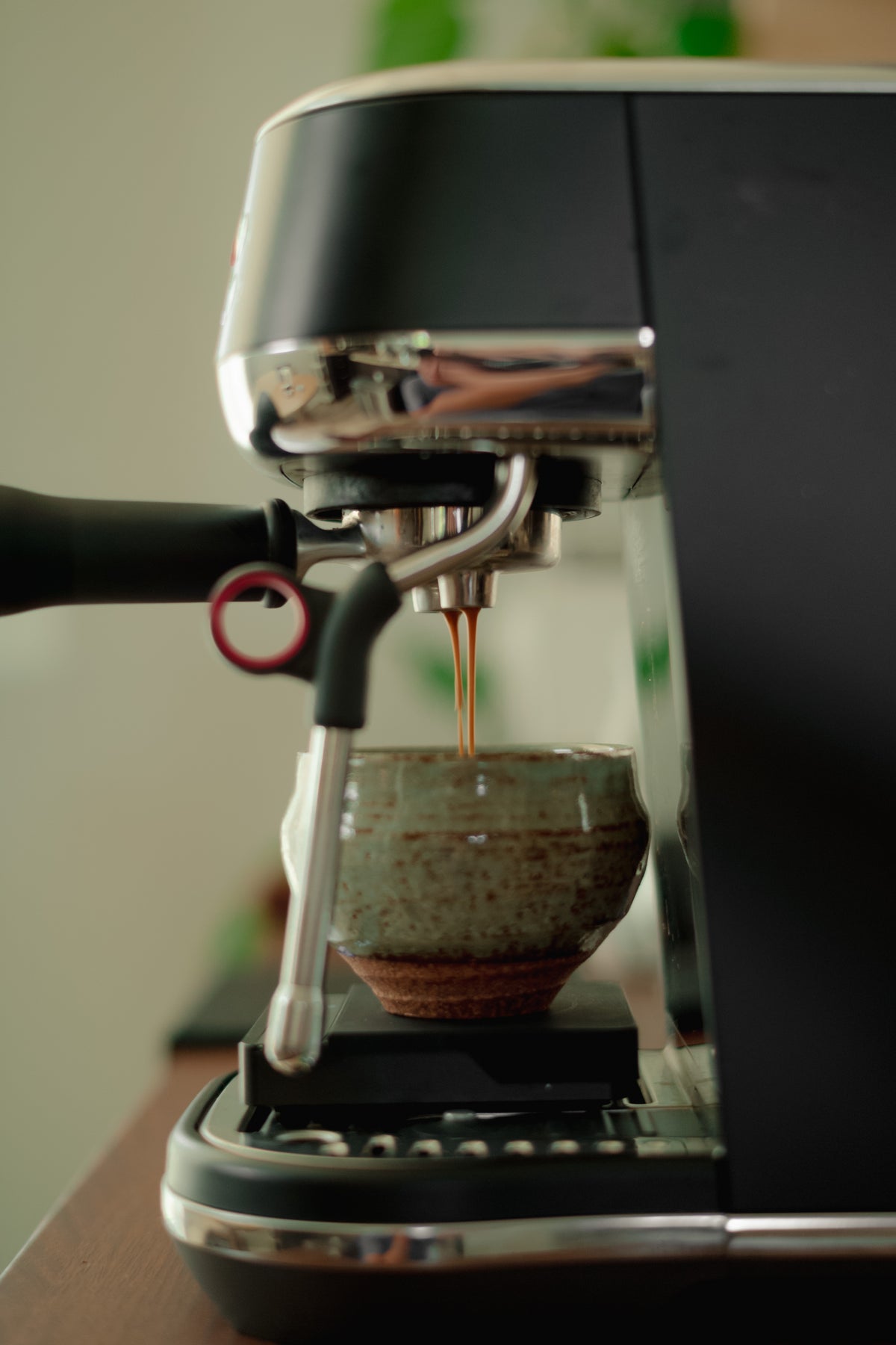 Espresso pouring into a ceramic cup on a scale