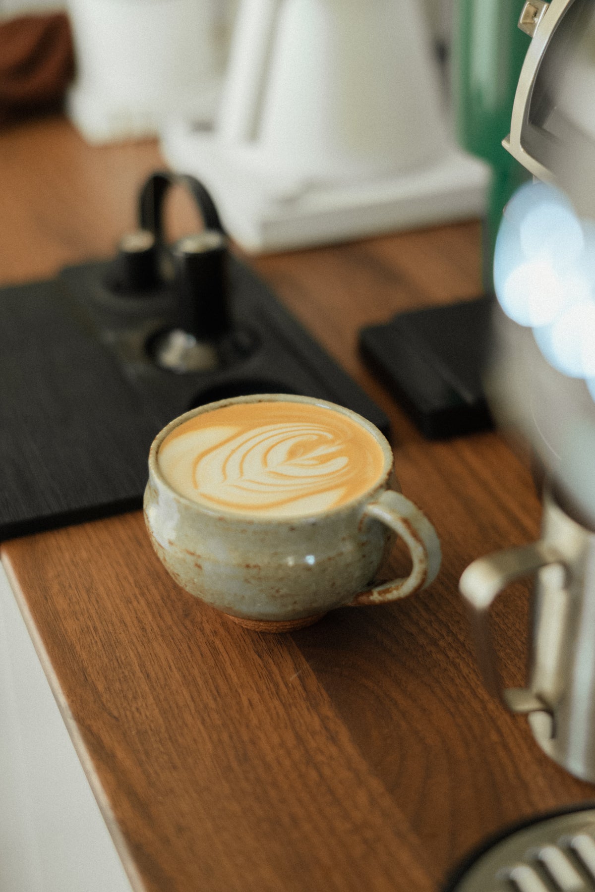 Latte art in a ceramic mug on the coffee counter