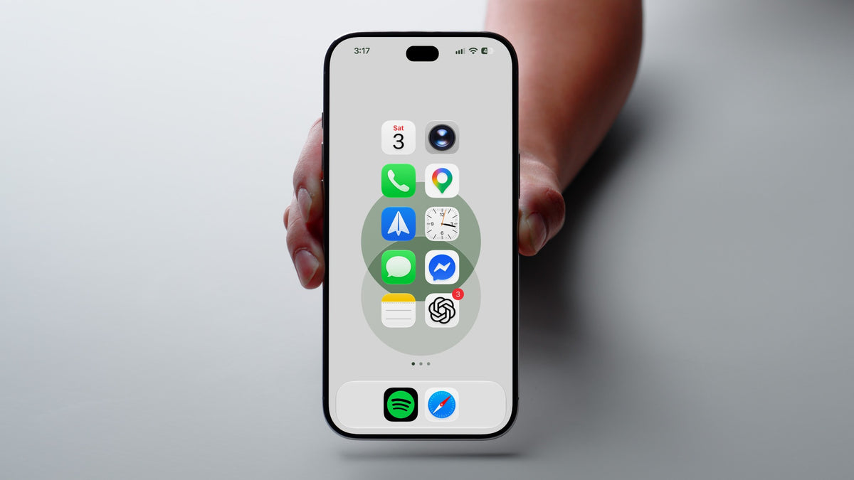 Joshua’s iPhone showing the Colorful Circles wallpaper with a clean home screen